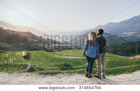 Young Caucasian Couple Overlooking Rice Terraces Of Sapa At Sunset In Lao Cai Region Of Vietnam