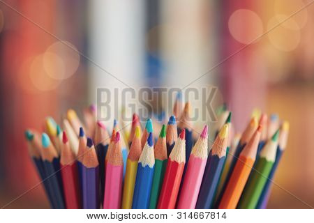 Colorful colored pencils on blurred bokeh background