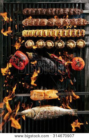 Big Set of Grilled Lule Kebab, Whole Barbecue Vegetables and Fish on Grill with Fire Top View. Skewered Bbq Minced Meat Mix of Poultry, Veal and Lamb with Mushrooms and Spices Collection