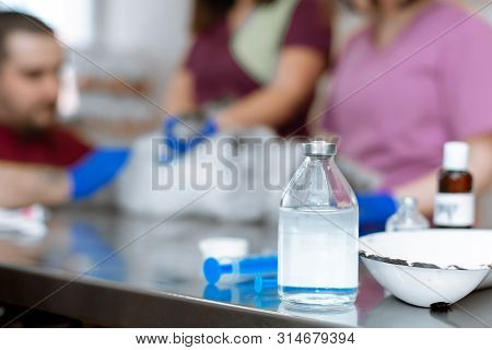 A Male Veterinarian Anesthesiologist Makes The Procedure For A Cat - A Catheterization Of The Bladde