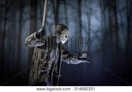 JULY 30 2019: Friday the 13th slasher Jason Voorhees with machete lurking in the woods - NECA Ultimate Jason action figure