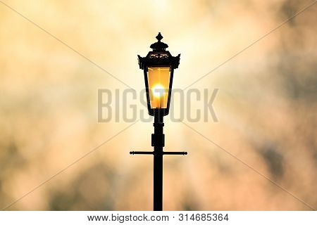 A Classic Style Of Lantern With Sunset Background (sillhouette)