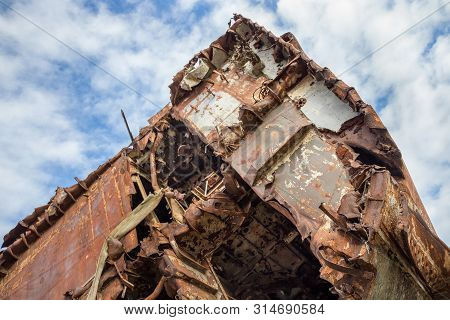 Huge Rusty Pieces Of Decommissioned Marine Ship That Was Cut And Left On The Shore.