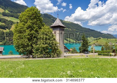 Lungern. Old Stone Bell Tower In A Swiss Village.