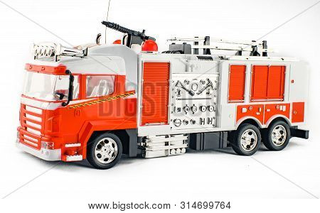 Toy Fire Engine With Fire Hose And Fire Extinguishing Tools. Childrens Toy Plastic Big Car With Isol