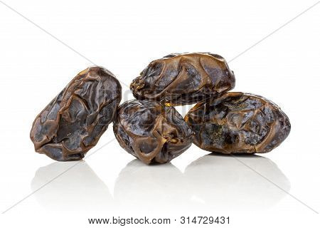 Group Of Four Whole Dried Brown Date Medjool Isolated On White Background