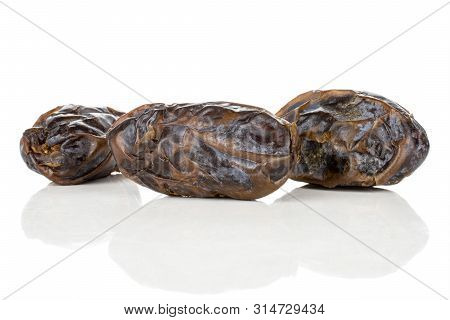Group Of Three Whole Dried Brown Date Medjool Isolated On White Background