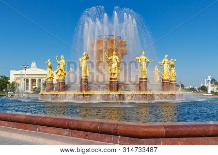 Moscow, Russia - July 22, 2019: Working Fountain Friendship Of Peoples In Vdnh Park In Moscow Agains