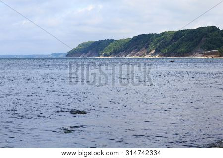 View Of The Sandy Cliffs And A Blue Water On The Baltic Sea.