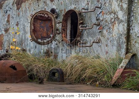 Rusty Part Of Decommissioned Marine Ship That Was Cut And Left On The Shore.