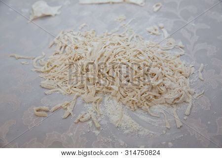 Cutting Long Dough Stripe For Cooking Pasta. Homemade Food Preparation Concept. Closeup Of Process O