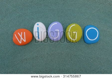 Wiggo, Masculin Scandinavian Given Name Composed With Multi Colored Stone Letters Over Green Sand