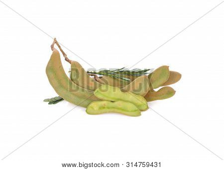 Whole And Cut Fresh Young Tamarind With Stem And Leaves On White Background