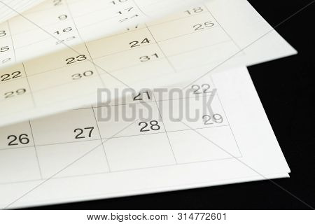 White Calendar Turning Pages With Dark Black Background Using As Time Fly, Season Pass Or Reminder A