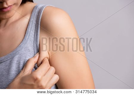 Close Up Woman Pulling Her Skin Underarm. Problem Armpit Fat Skin Concept.
