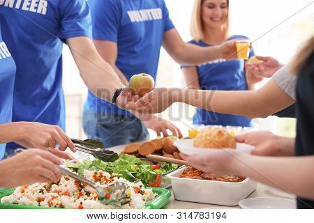Volunteers Serving Food To Poor People, Closeup