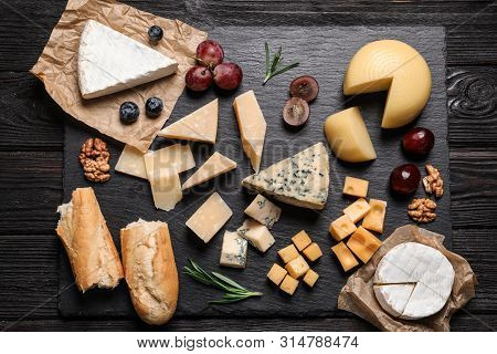 Flat Lay Composition With Different Types Of Delicious Cheese On Slate Board