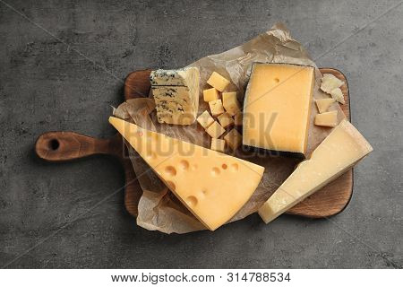 Different Delicious Cheeses Served On Grey Table, Top View