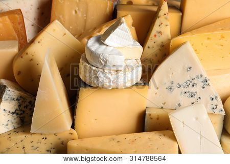 Different Types Of Delicious Cheese As Background, Closeup