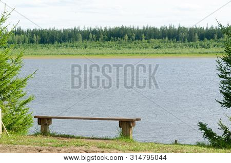 Bench For Rest Of Tree Is On The Cliff North Of The River Vilyui With Taiga Forest On The Other Side