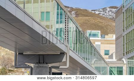 Panorama Frame Skybridge Connected To A Modern Building With Mountain And Blue Sky Background