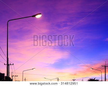 Streetlight With Highlight On Fantasy Sky Background And Pink Clouds After Sunset In Winter