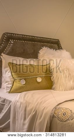 Vertical Frame Double Bed With Fluffy Pillows Against The Upholstered Belgrave Headboard
