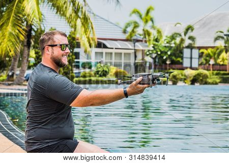 Bearded Man Launches Drone For Flight, With Which You Can Take Photos And Video Filming, Near The Sw