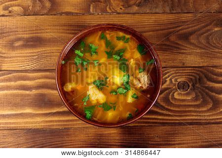 Kharcho Soup With Meat And Rice On Wooden Table. Top View
