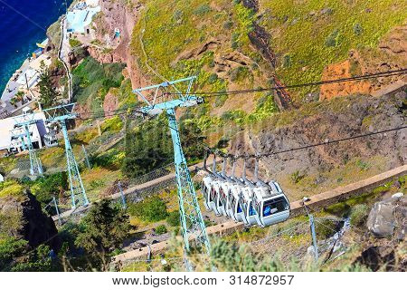 Fira, Santorini Island, Greece Panoramic View, With Cable Car Cabins From Old Port, High Volcanic Ro