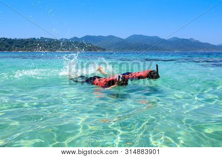 Couple Trourist Snorkeling In Beautiful Sea In Thailand