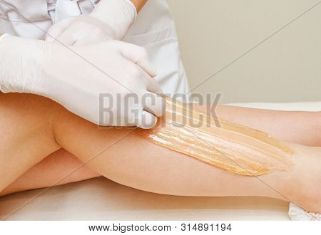 Cosmetologist Beautician Waxing Female Legs In The Spa Center Beauty Salon Cosmetology Concept