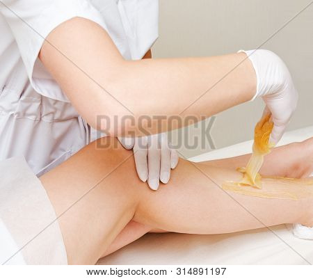 Cosmetologist Beautician Waxing Female Legs In The Spa Center Beauty Salon Cosmetology Concept