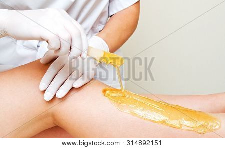 Cosmetologist Beautician Waxing Female Legs In The Spa Center Beauty Salon Cosmetology Concept