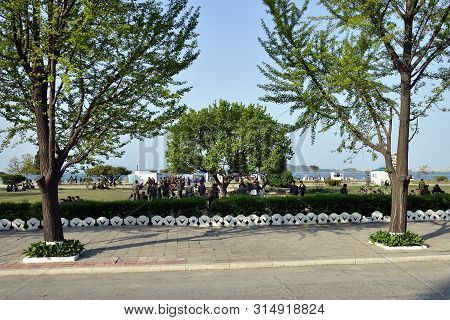 Wonsan, North Korea - May 3, 2019: Local People Have A Rest After Working Day In Park Along The Prom
