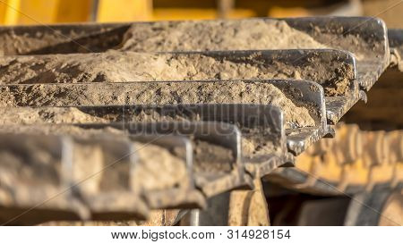 Panorama Metal Grouser Pad Close Up Of A Yellow Construction Vehicle On A Sunny Day.