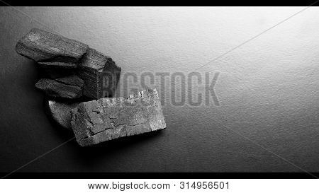 Black Color Wooden Charcoals On Dark Background Top View