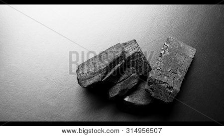 Black Color Wooden Charcoals On Dark Background Top View