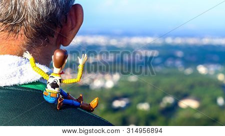 Songkhla, Thailand - November 30, 2018: Happy Holidays! Woody Sit On The Shoulder Old Man Waving At 