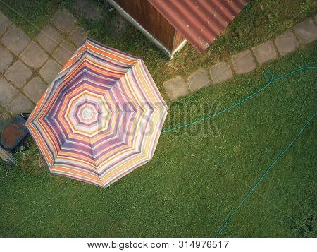 Bird Eye View Of A Sun Umbrella In The Backyard, Cloudy Day Shot
