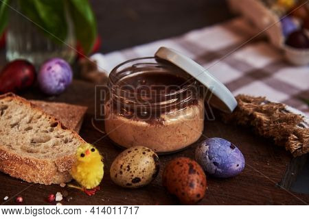 Meat Pate In A Glass Jar On A Cutting Board And Painted Quail Eggs. Easter Background, Meat Delicaci