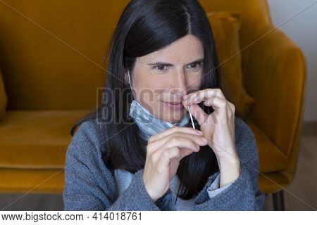Young Woman With Protective Mask Taking Auto Test For Covid-19 At Home With Antigen Kit. Introducing