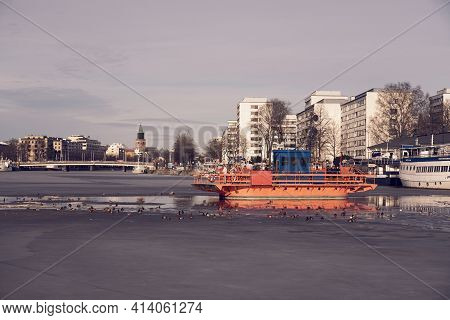 Turku, Finland- March 23, 2021: Fori Ferry On Frozen Aura River During Sunset.