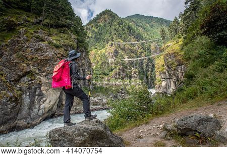 Tourist Woman Looking To Tenzing-hillary Suspension Bridge, The Bridge Build For Crossing The River 