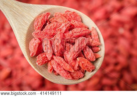 Dried Chinese Wolfberries Or Goji Berries In Wooden Spoon.