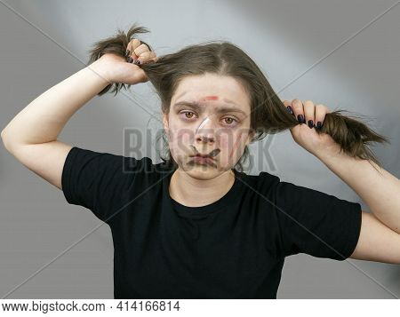 Portrait Teenage Girl Holding Hair With Her Hands,aggressively Painted Face.protest Action,adolescen