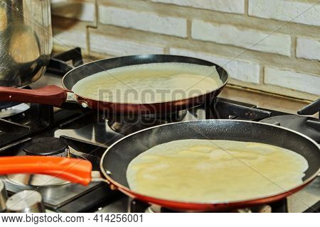 Pancakes Are Fried In Pans On A Gas Oven. Step By Step Recipe.