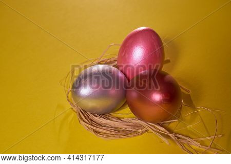 Pearl Colored Eggs In The Nest On A Yellow Background. Easter Concept.