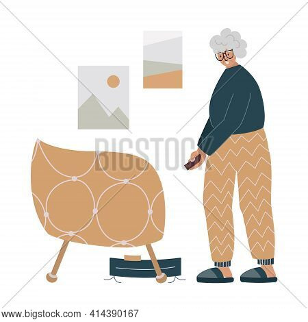 Old Woman Using A Robot Vacuum Cleaner.