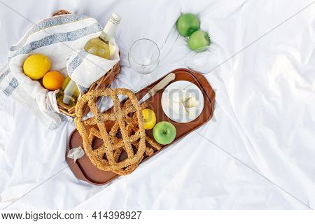 Breakfast At Sunrise, On The Grass White Sheet With A Tray With Cheese And Vine, Dry Bread, Apple, L